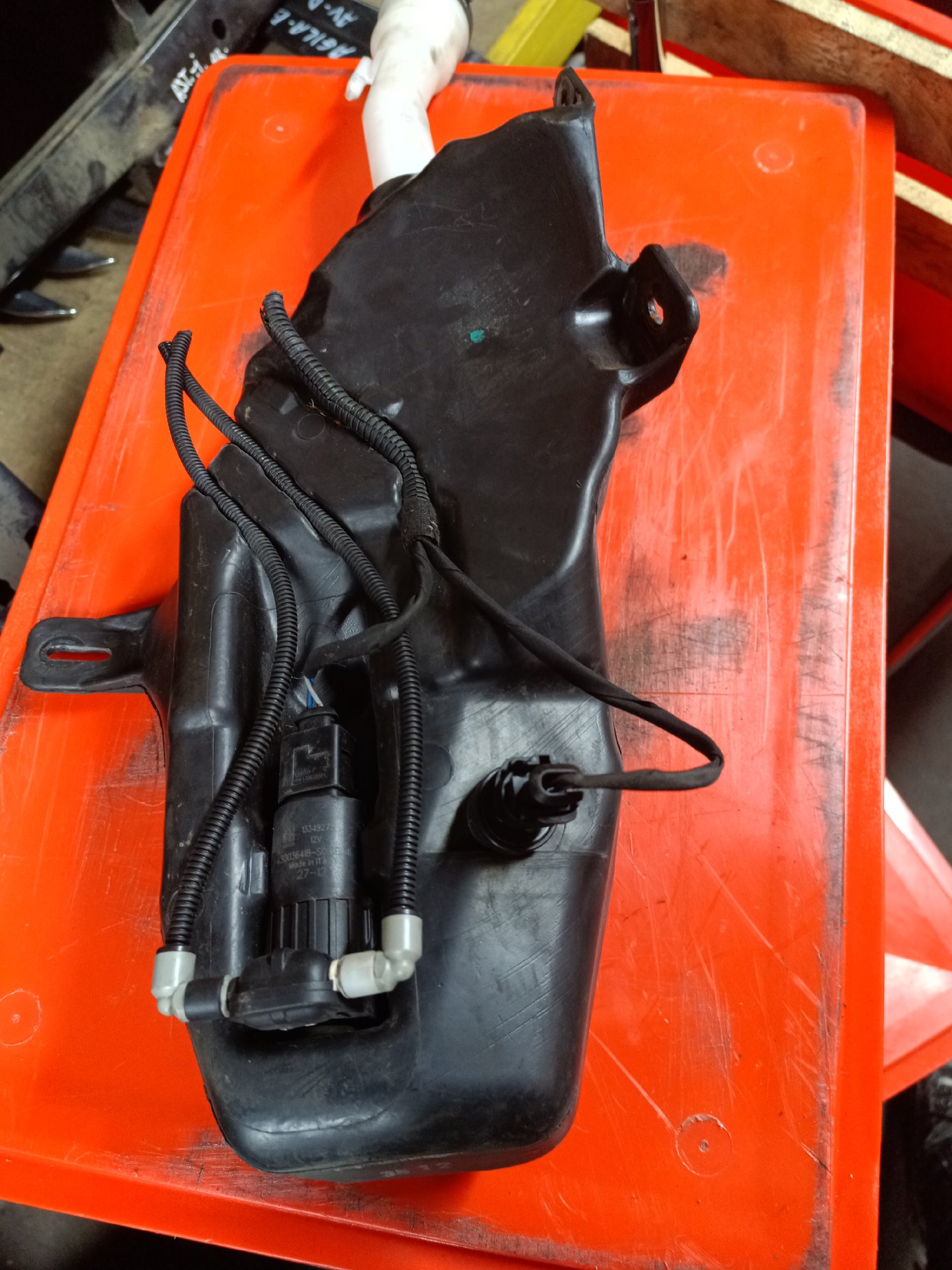 Windshield washer reservoir with pump