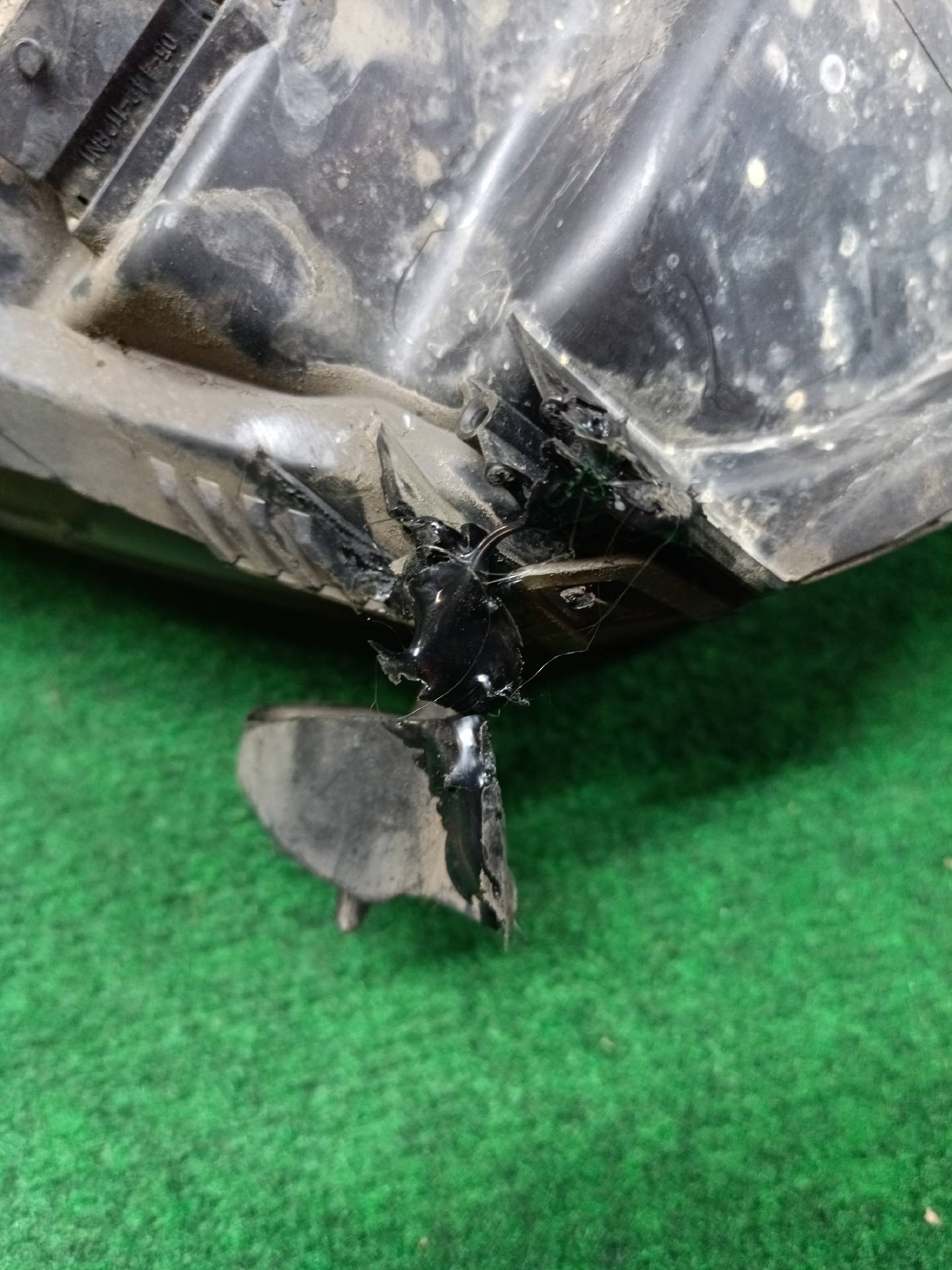 Left front headlight assembly, mounting tab broken - needs repair